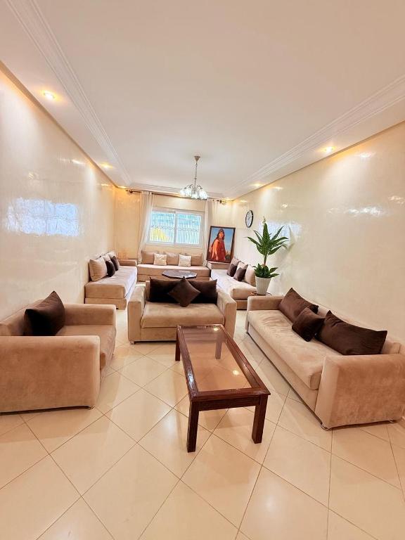 a large living room with couches and a table at la perle de tanger in Tangier