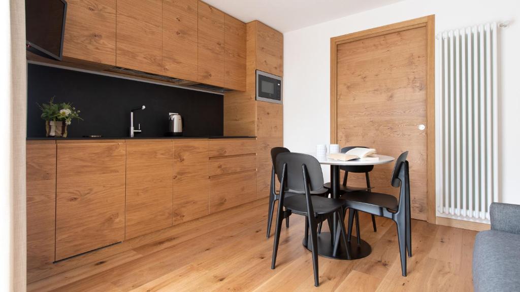 a dining room with wooden walls and a table and chairs at Italianway - Al Forte 6 in Valdisotto