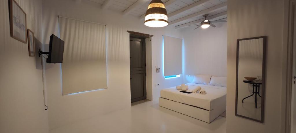 a living room with a white couch and a mirror at La Priva Calma in Agios Ioannis