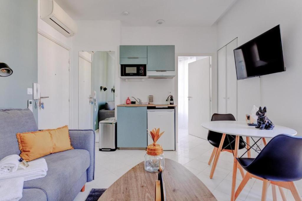 un salon avec un canapé et une table dans l'établissement LA PANTHERE studio design central et calme, idéal pour un séjour en couple ou congrès, à Cannes