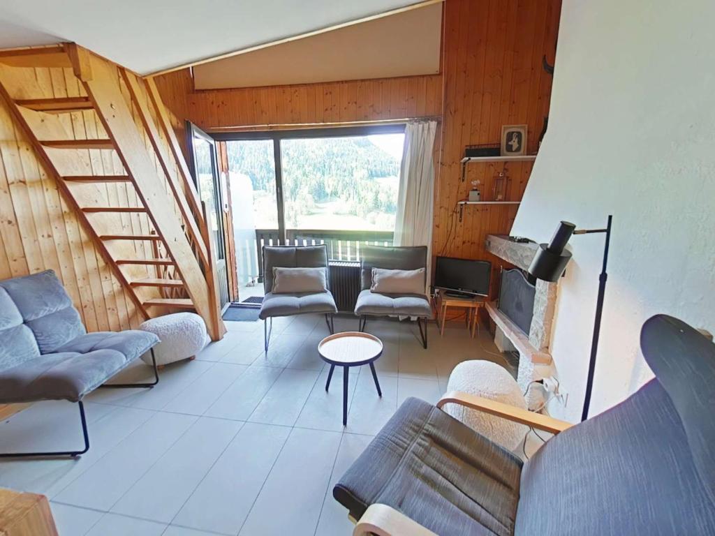 un salon avec des canapés et une cheminée dans l'établissement Appartement cosy avec cheminée et balcon, 6 couchages, Le Grand-Bornand - FR-1-241-63, au Grand-Bornand