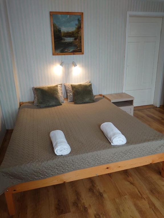 a bedroom with a large bed with two pillows at Dzīvoklis Vecliepājā in Liepāja