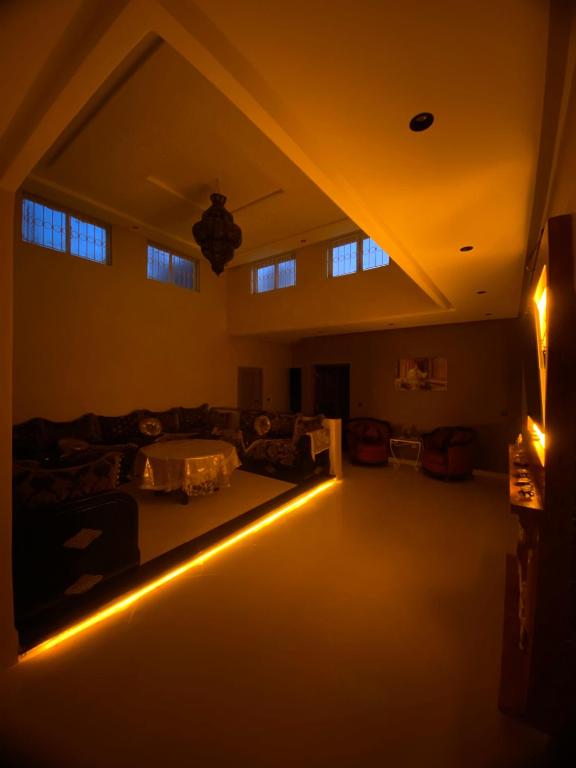 a living room with a couch and lights on the floor at Villa cherif in Chouiter