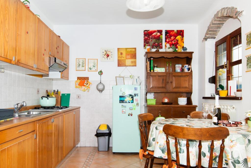 a kitchen with a table and a refrigerator at Apartments Baredi in Izola