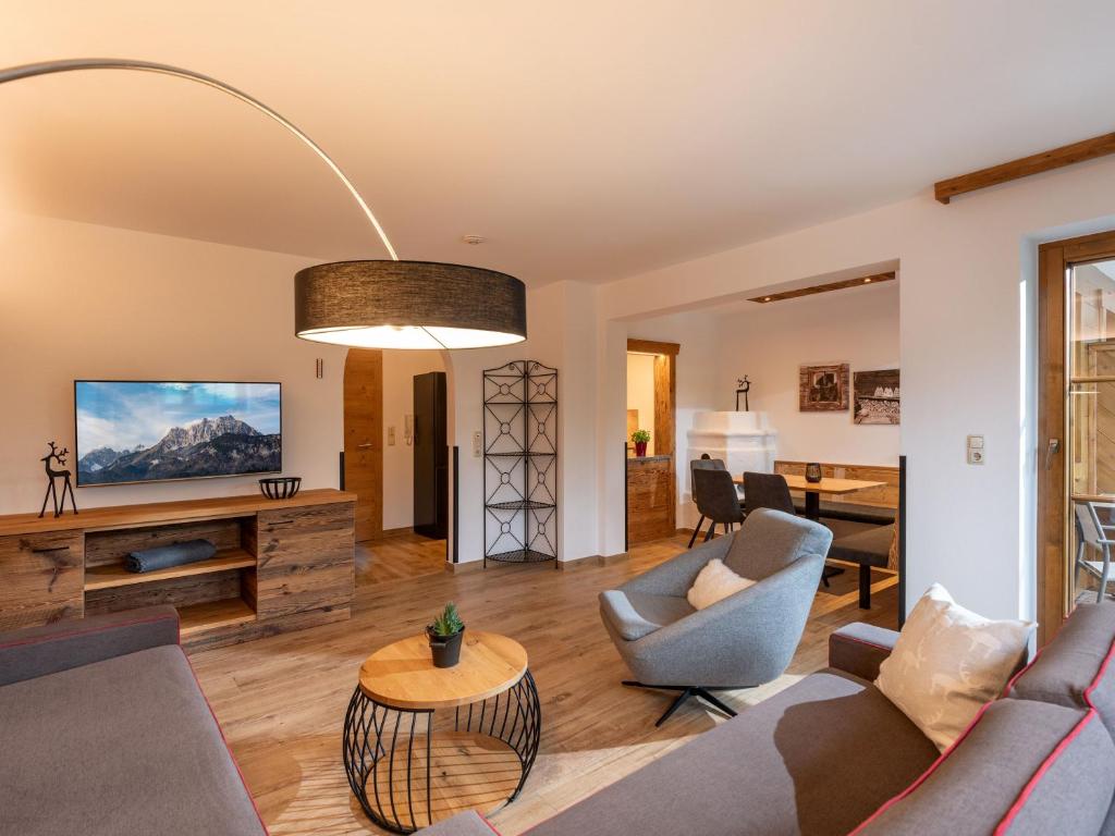 a living room with a couch and a table at Appartements Schedererhaus in Going