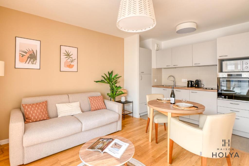 un salon avec un canapé et une table dans l'établissement Appartements pour 2, 4, ou 5 personnes - Clichy - Proche Paris, à Clichy