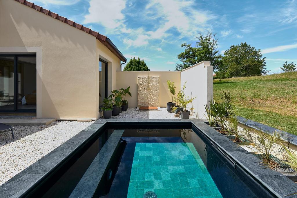 a swimming pool in the backyard of a house at Secluded Pool Villa near Castle in Beynac-et-Cazenac