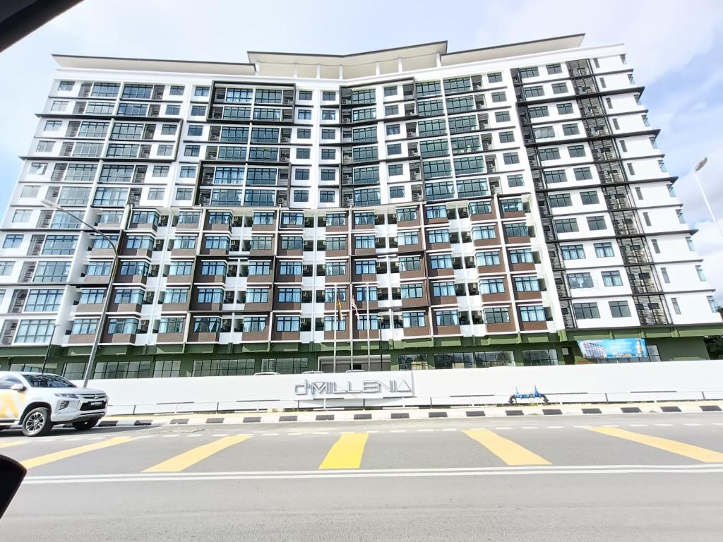 a tall building with a car parked in front of it at SS D'Milennia Residence Samarahan 