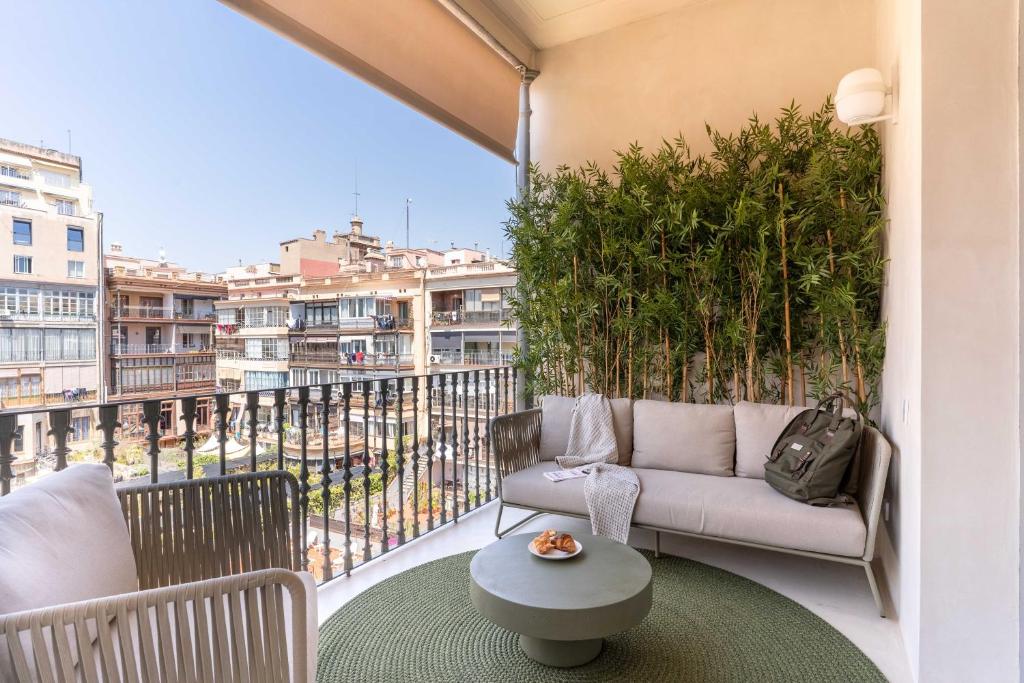 a balcony with a couch and a table at BCN Apartments 41 in Barcelona