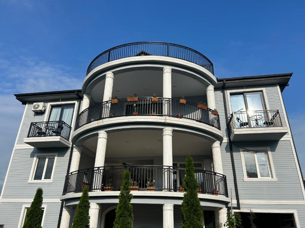 a large building with balconies on top of it at Shine Hill შაინ ჰილი in Tsinsvla