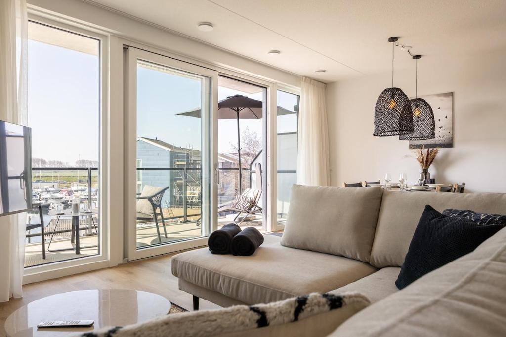 a living room with a couch and a table at Apartment Havenzicht 8a Kortgene in Kortgene