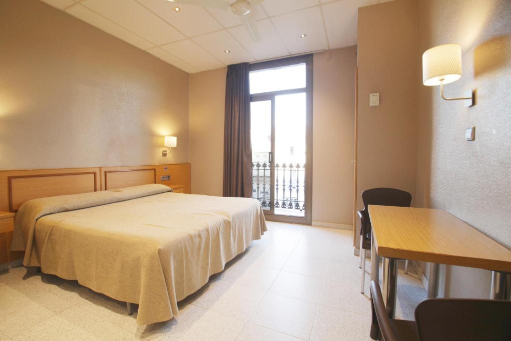 Postel nebo postele na pokoji v ubytování Hostal Nuevo Colon