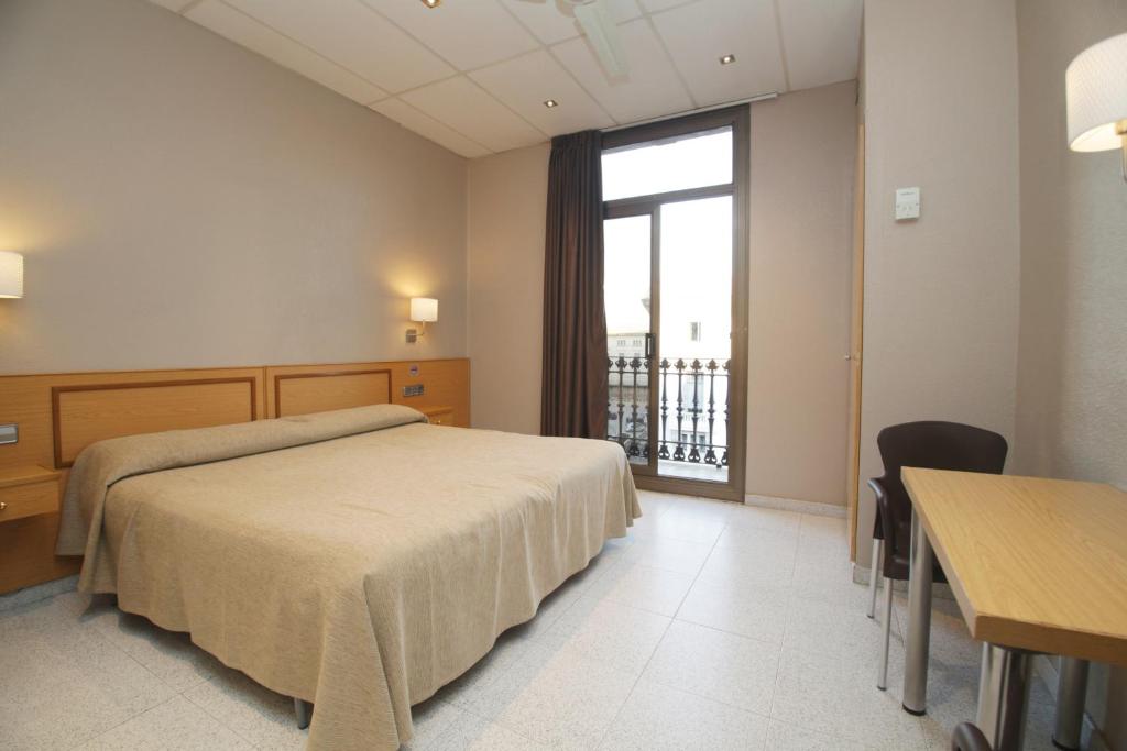 Postel nebo postele na pokoji v ubytování Hostal Nuevo Colon