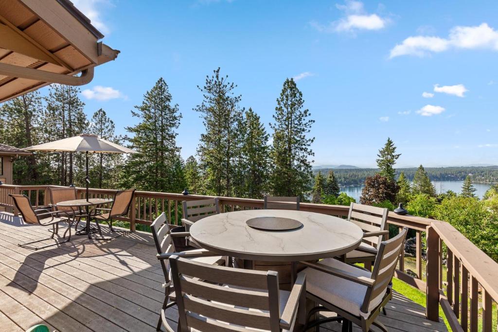a patio with a table and chairs on a deck at Lake View on Lookout Coeur d' Alene ID in Coeur d'Alene