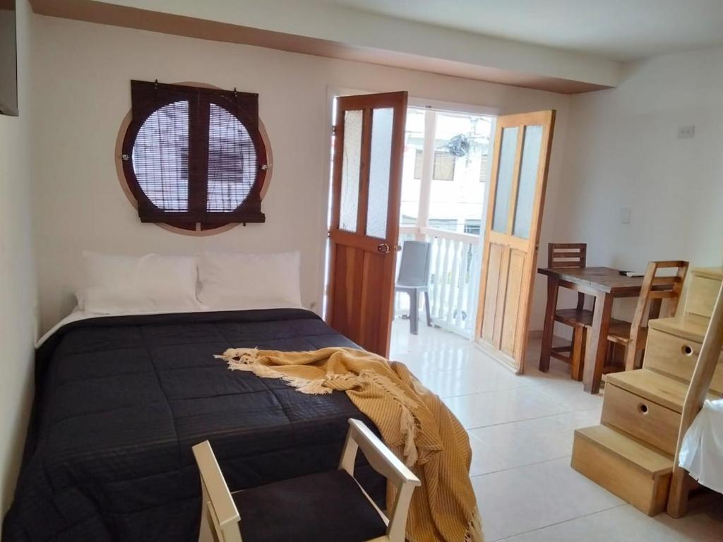 a bedroom with a bed with a black blanket on it at Hotel Boutique Tierra Del Mar Cartagena in Cartagena de Indias
