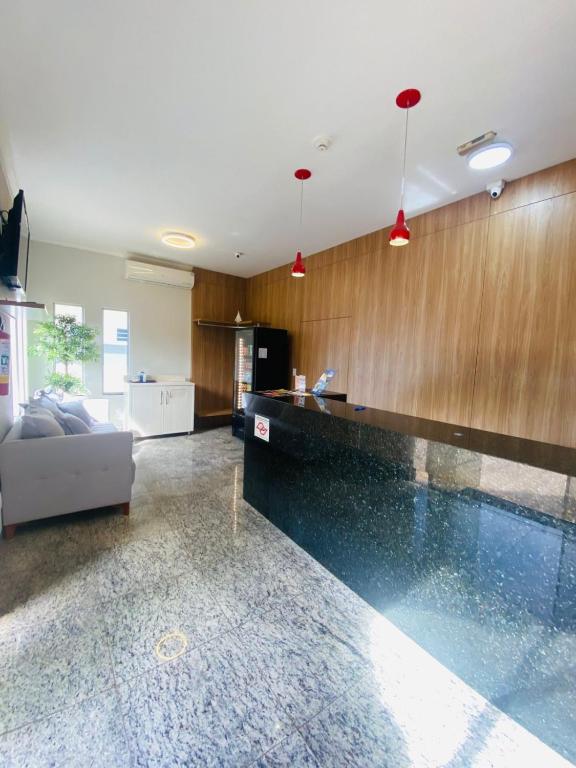 a living room with a swimming pool in a house at Glória Hotel in Olímpia