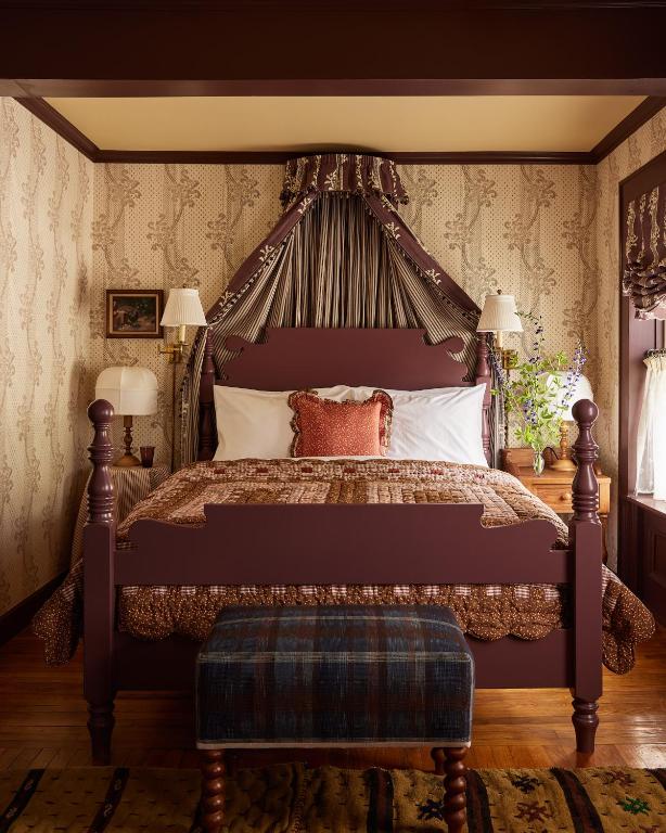 a bedroom with a large bed with a canopy at Six Bells Countryside Inn in Rosendale