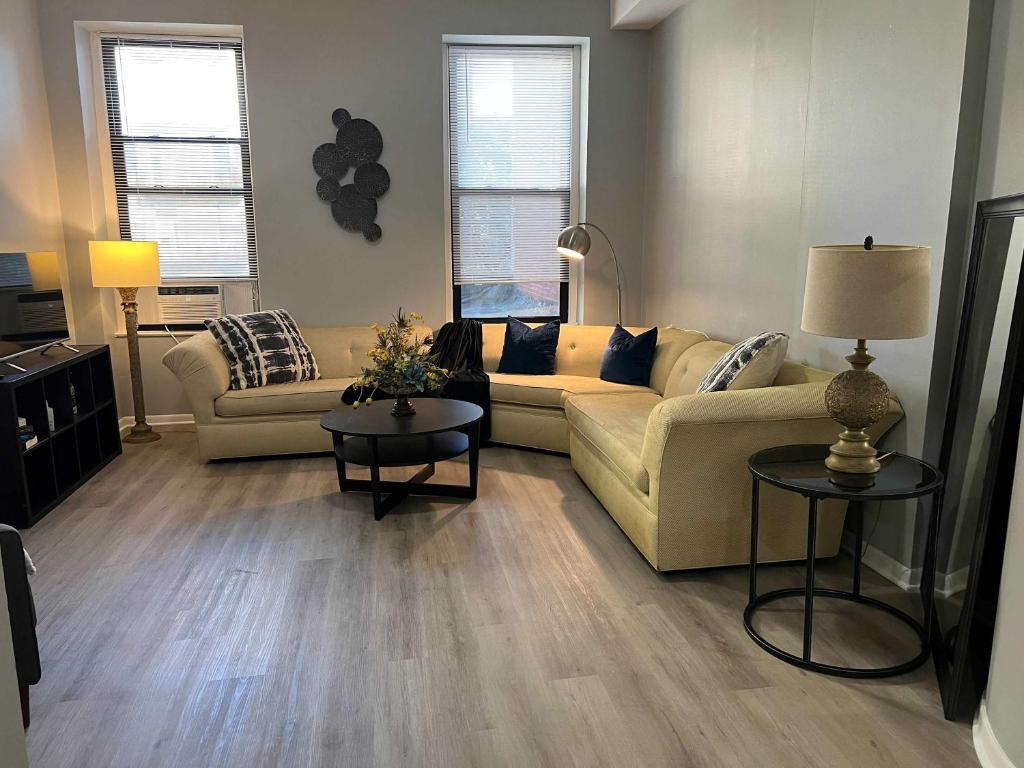 a living room with two couches and two tables at South Loop 2 Bedroom Apt in Chicago