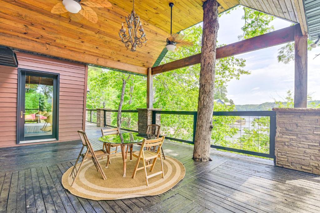 a patio with a table and chairs on a deck at Upscale Getaway on Smith Lake with Boat Dock in Arley