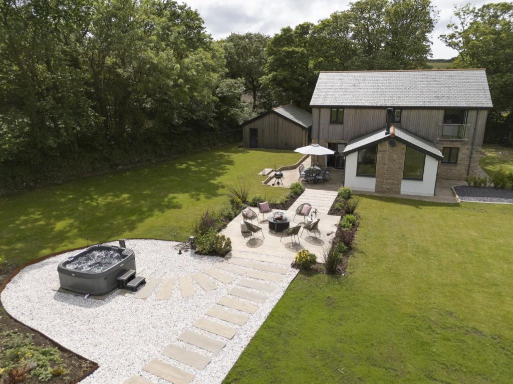 an overhead view of a backyard with a grill and a house at Highfield Barton in Camborne