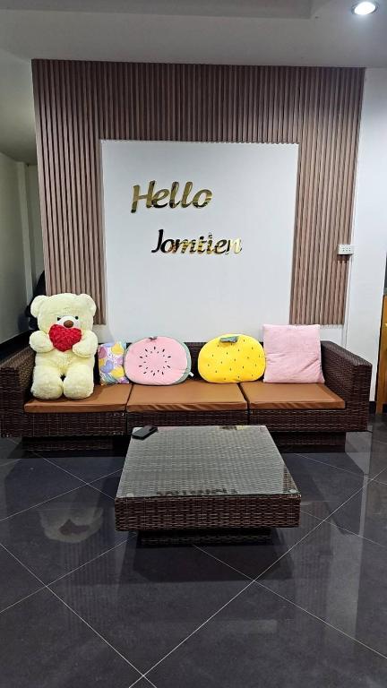 two teddy bears sitting on a bench in a store at Hello Jomtien in Jomtien Beach