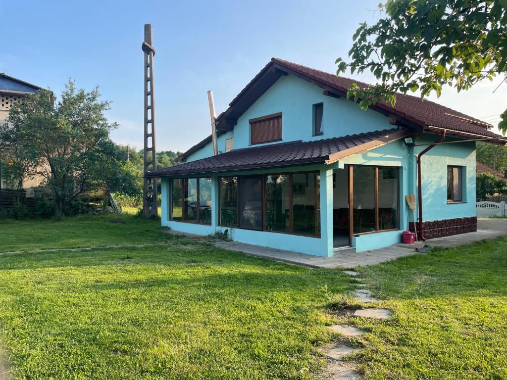 a house with a lot of windows at Casa Herban in Teliucu Inferior