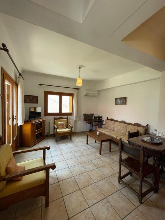 a living room with a couch and a table at Lula's House in Skiathos Town