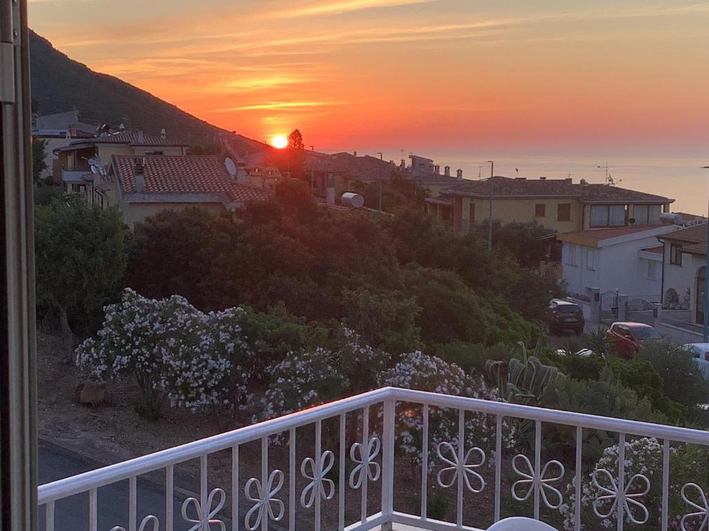 a view of a sunset from a balcony at BenitiKe House in Cala Gonone