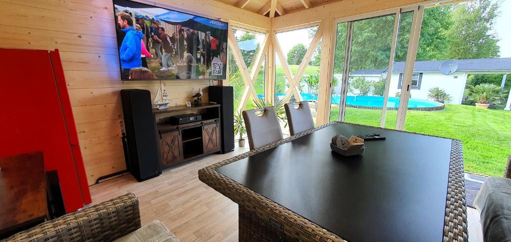 a living room with a large black table and chairs at Fewo Traum in Neppermin