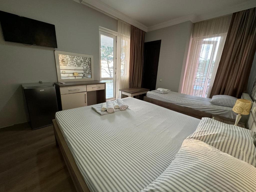 Postel nebo postele na pokoji v ubytování Karo Hotel