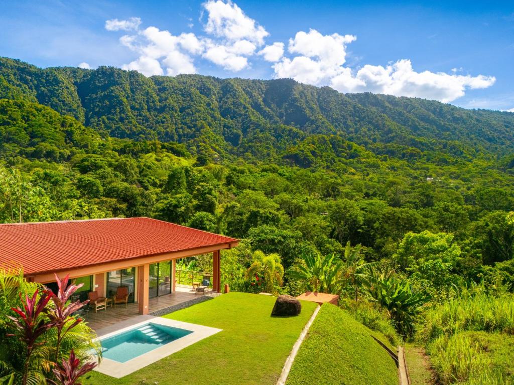 a villa with a swimming pool and a mountain at Villa Roca Ocean to Mountain Views - by Pura Villas in Ojochal