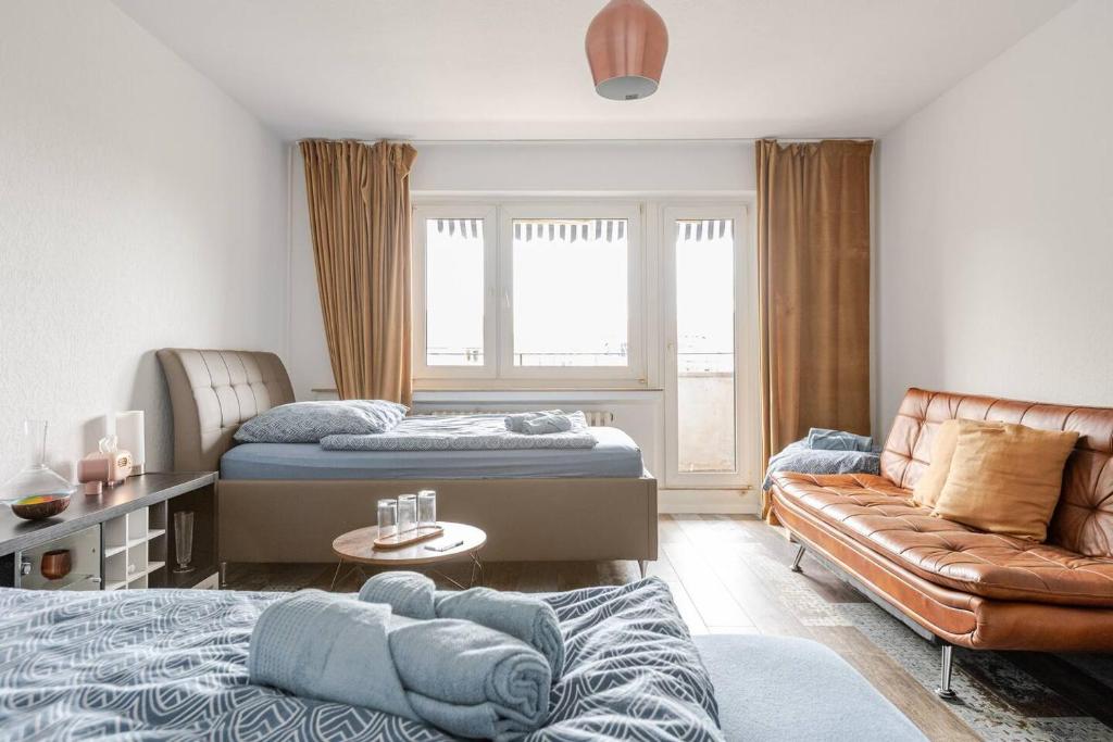 a living room with two beds and a couch at Zimmer mit Flair Köln-Messenähe in Cologne