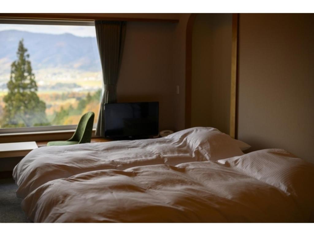 Postel nebo postele na pokoji v ubytování HOKURYUKO HOTEL North NAGANO - Vacation STAY 44512v