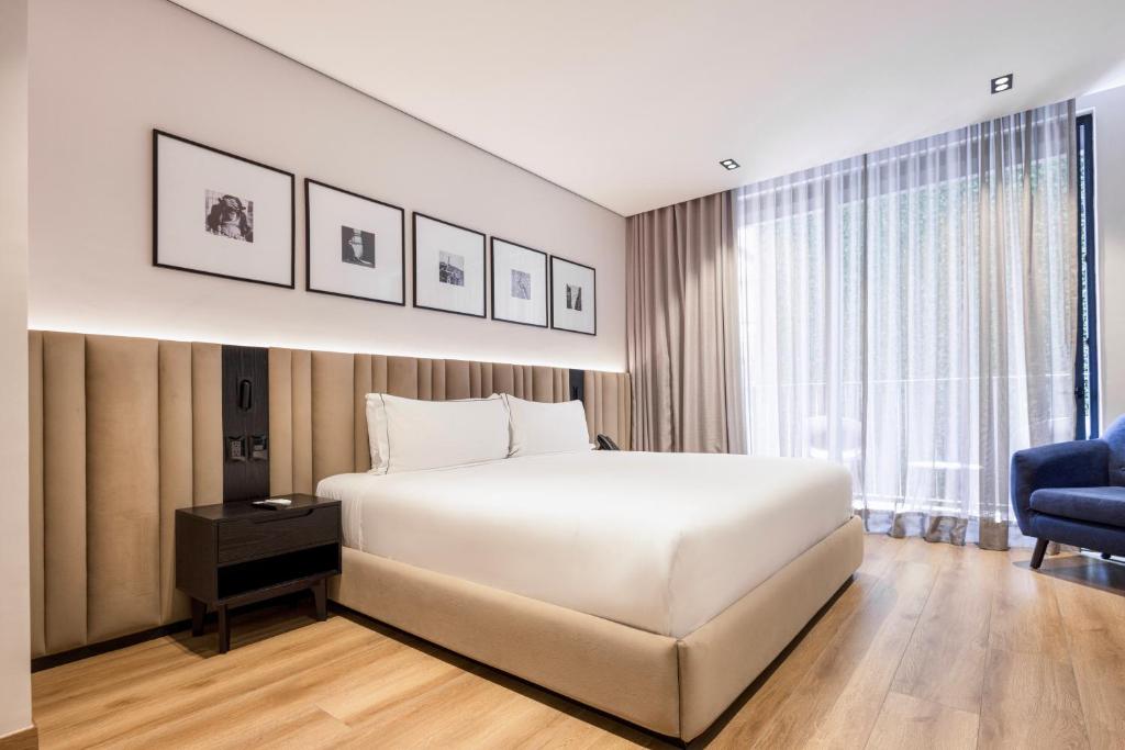 Postel nebo postele na pokoji v ubytování Vuestro Hotel Boutique