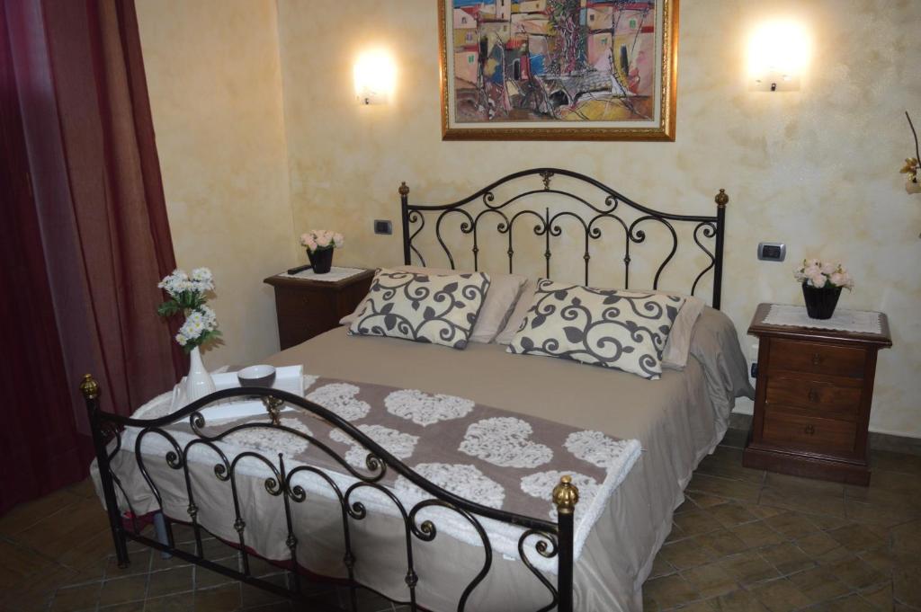 a bedroom with a black bed with pillows on it at Villa Tre Colli Agri B&B in Ariano Irpino