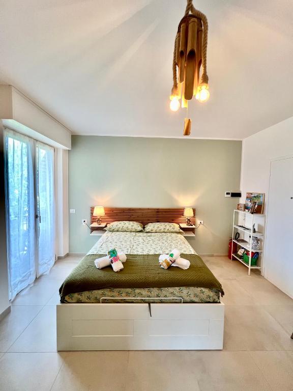 a bedroom with a large bed with two stuffed animals on it at JungleHouse in Abbadia Lariana