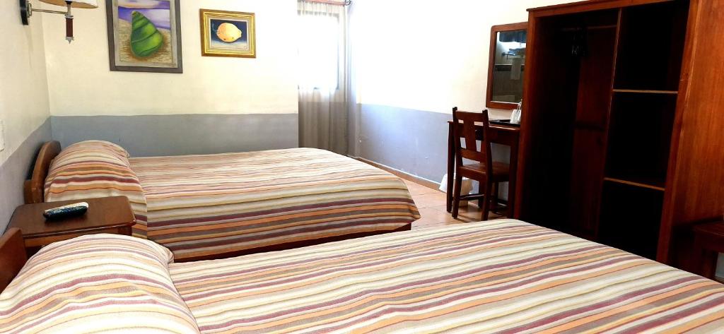 Postel nebo postele na pokoji v ubytování Hotel Playa Bonita Tela