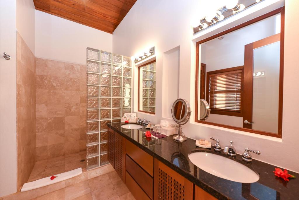 a bathroom with a sink and a shower at Victoria House Resort & Spa in San Pedro