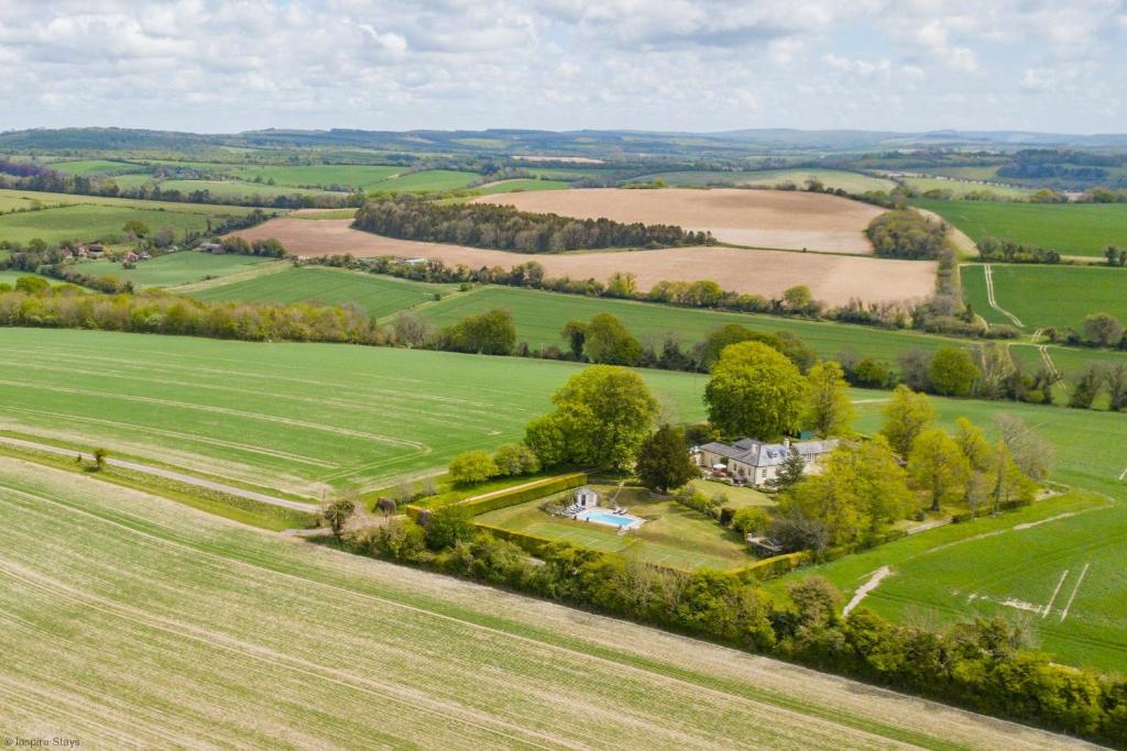 an aerial view of a house in the middle of a field at Telegraph House by inspirestays-com in Chichester