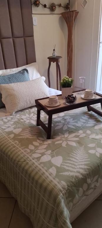 a coffee table sitting on top of a bed at Apê da Terezinha in Rio de Janeiro