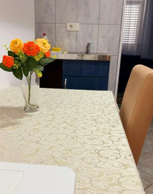 a vase of flowers sitting on a kitchen table at Apartments Mitrovići Miločer in Sveti Stefan