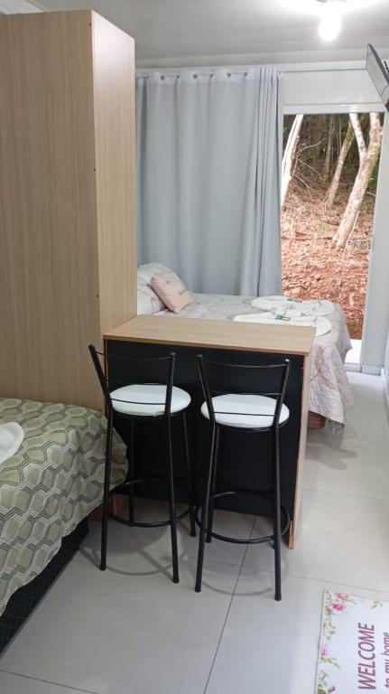 Postel nebo postele na pokoji v ubytování Pousada Jardim Encantado - Suítes em Container na cidade do Cristo Protetor - Encantado RS
