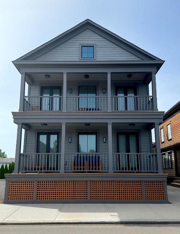 a large house with a large front porch at Brand New Construction! 3 Unit5 Bed Property in Newport