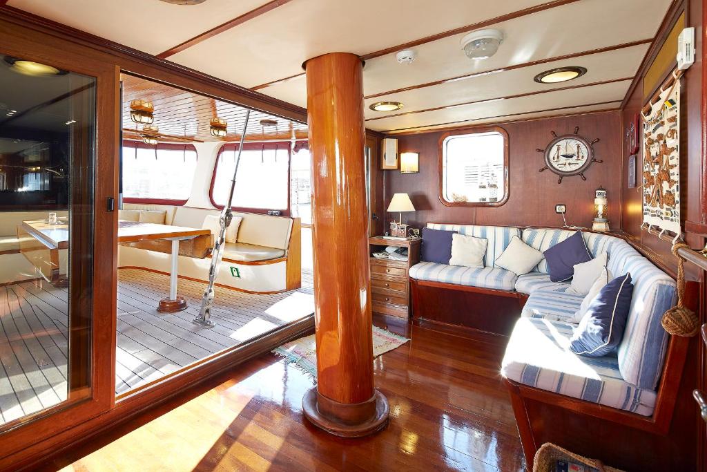 a room with a couch and a table in a boat at Southern Cross in Barcelona
