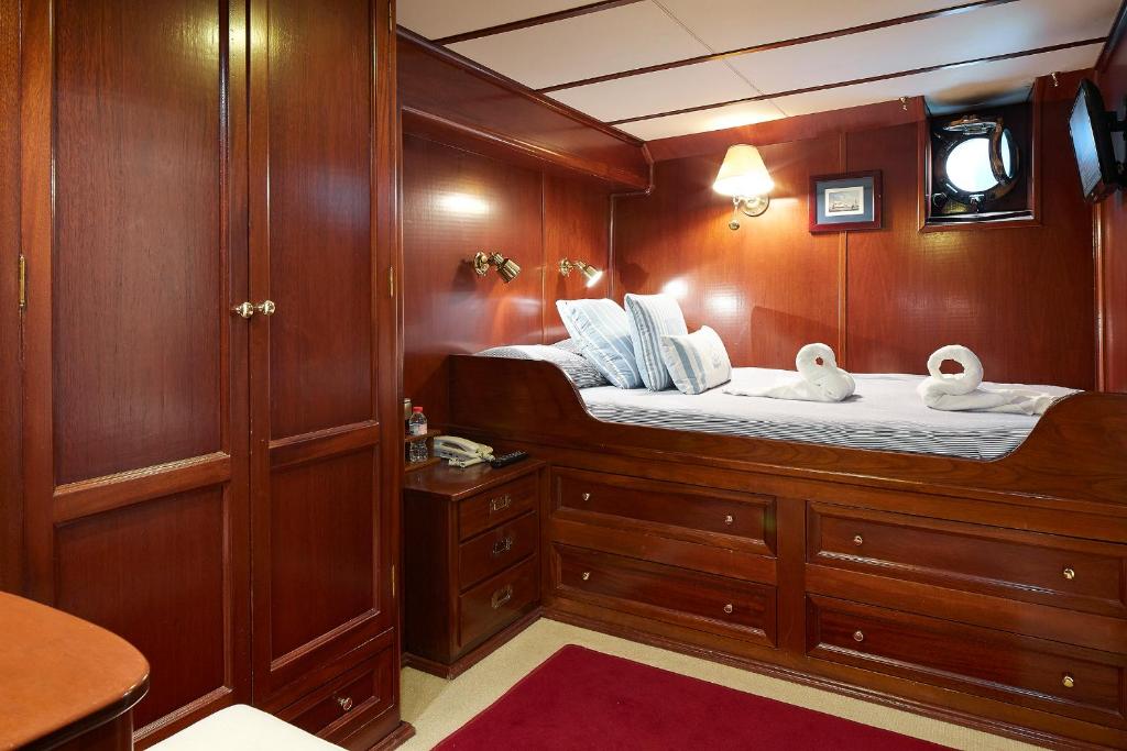 a boat cabin with a bed with swans on it at Southern Cross in Barcelona