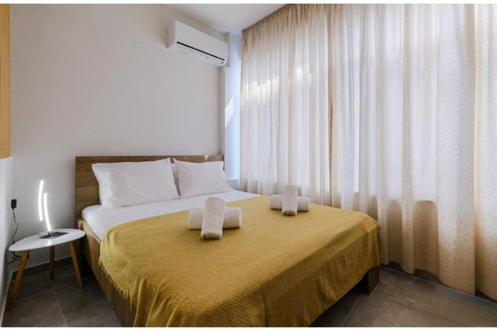 a bedroom with a bed with two towels on it at Ladadika Vibes Studio 2 in Thessaloniki