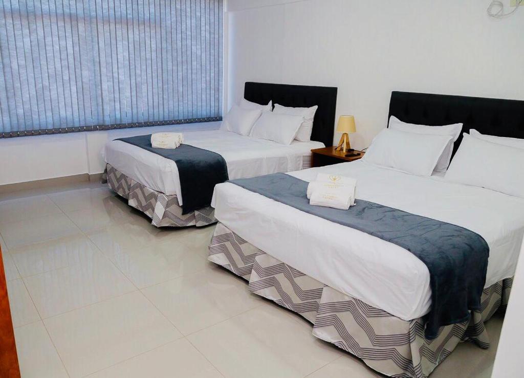 Postel nebo postele na pokoji v ubytování Hotel Luis Pablo