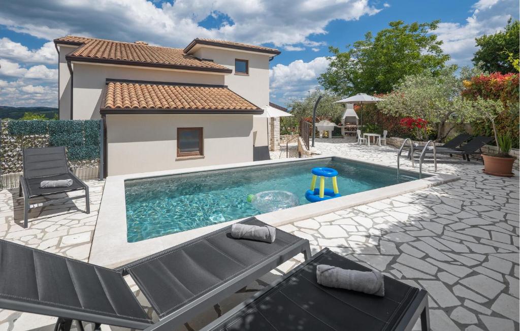 a swimming pool in front of a house at 4 Bedroom Gorgeous Home In Nova Vas in Nova Vas