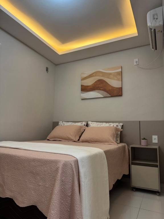 a bedroom with a bed and a yellow ceiling at Belíssimo Apto a 2 km da Litorânea in São Luís