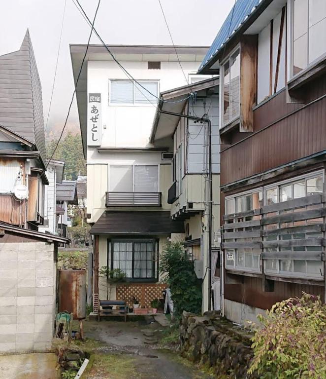 an alley in front of a building at Azetoshi Lodge in Nozawa Onsen